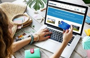 woman using a laptop and holding credit card while shopping securely online